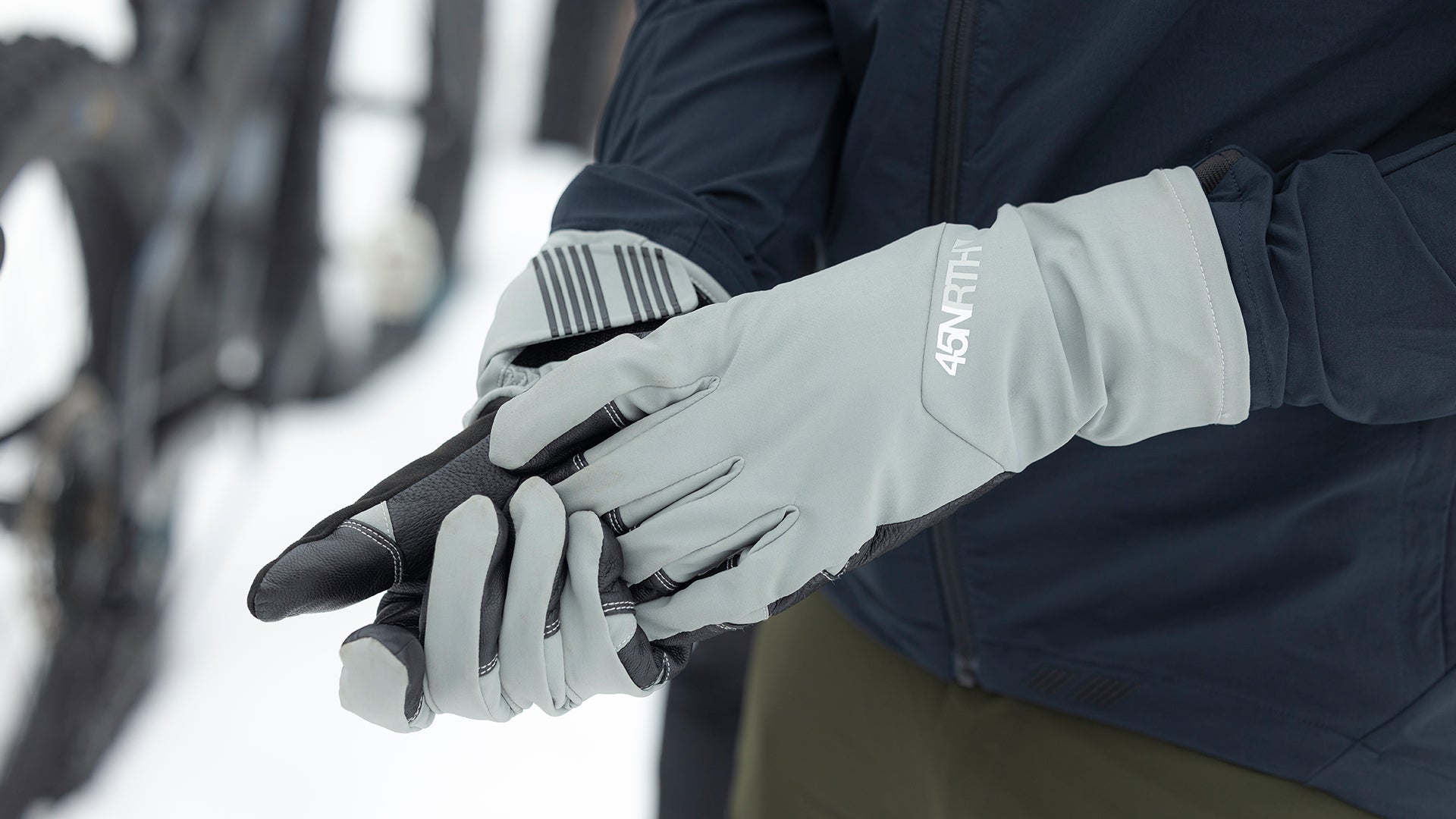 Close-up of cyclist wearing 45NRTH Sturmfist 5 winter gloves outside