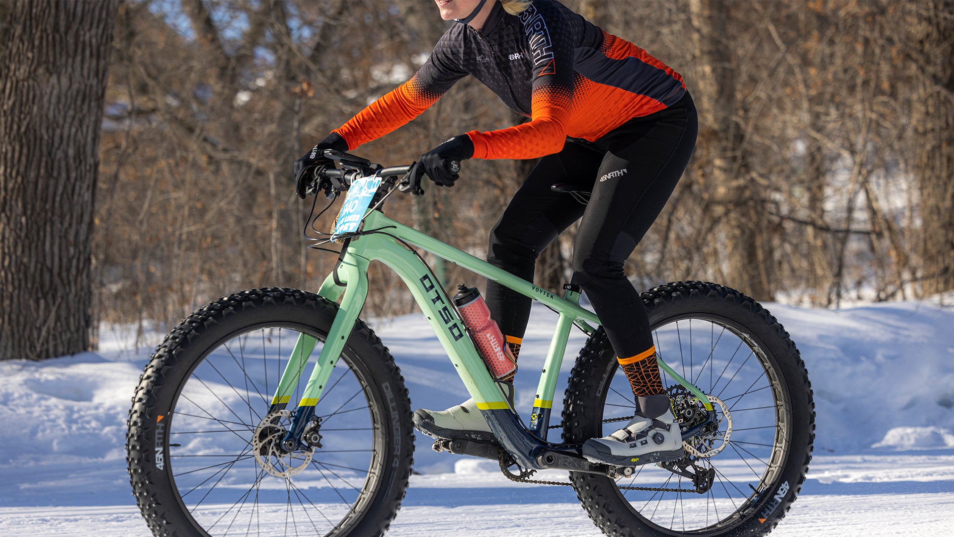 45NRTH cyclist riding fat bike on snowy road wearing Naughtvind Bib Knickers
