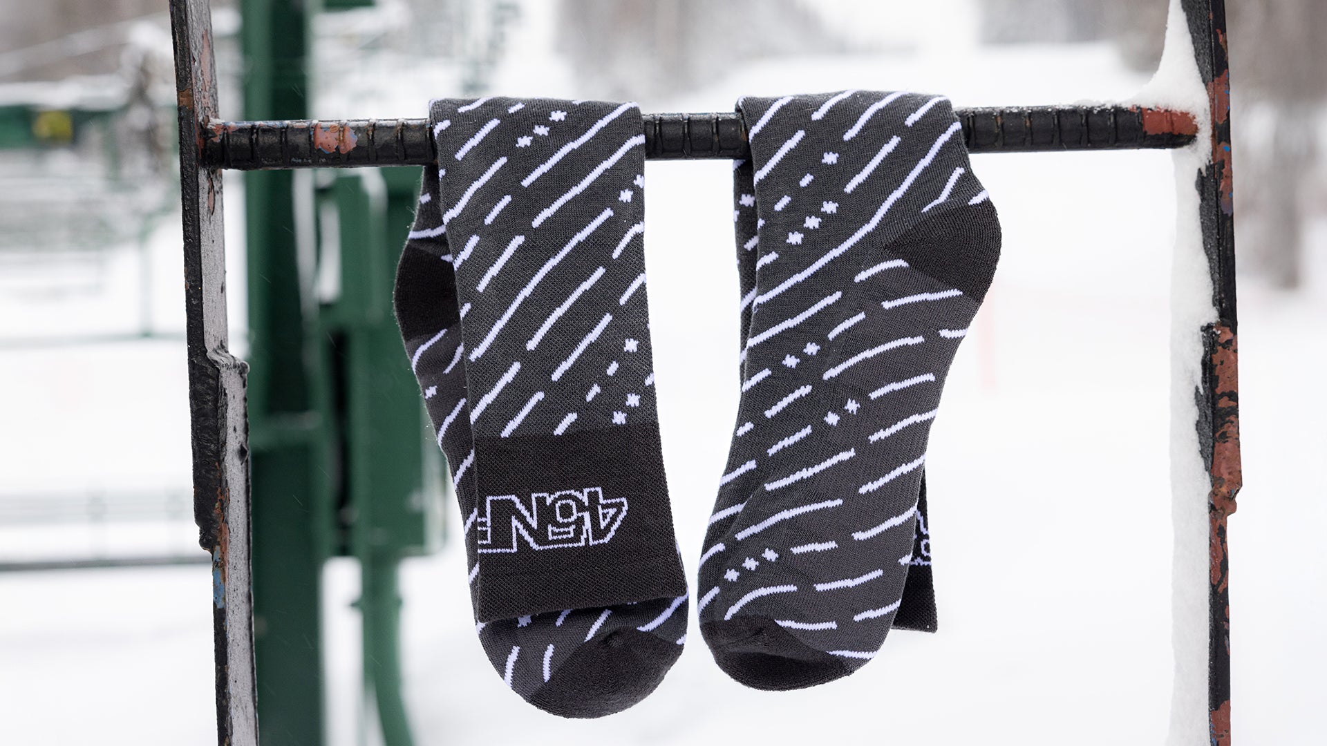 45RTH Socks hangin from snowy chairlift ladder