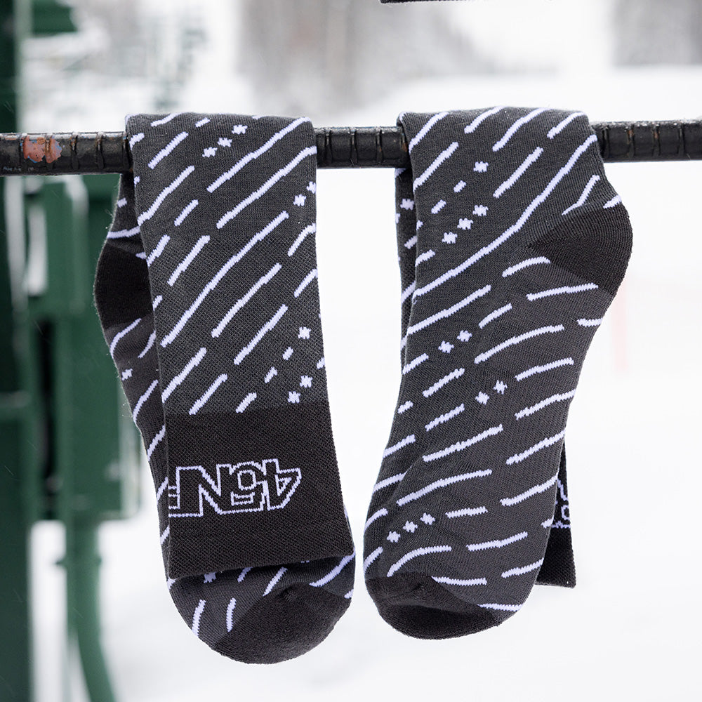45RTH Socks hangin from snowy chairlift ladder