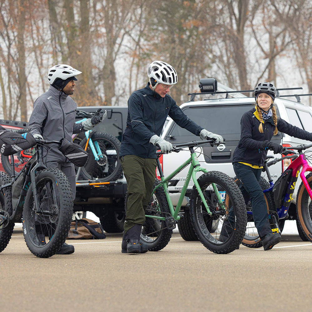 Three fat bikers ready to ride snowy trails wearing 45NRTH gear