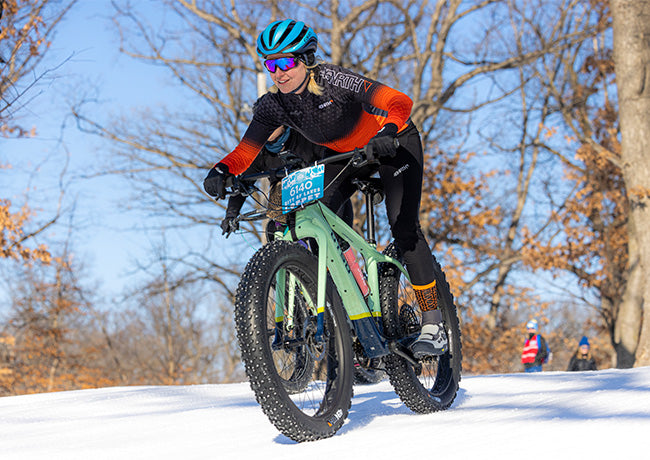 Chelsea Strate racing fat bike on groomed snow track