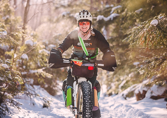 Jill Martindale riding loaded fat bike on snowy trail in forest